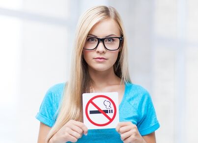 girl holding a smoking cessation sign at the entrance